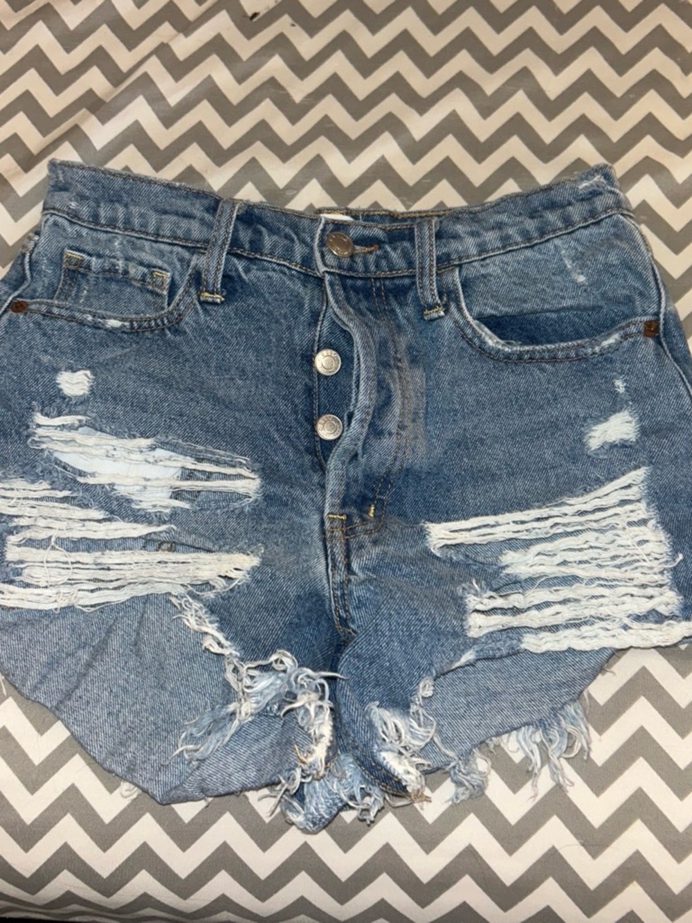 High-Rise Distressed Denim Shorts in Blue